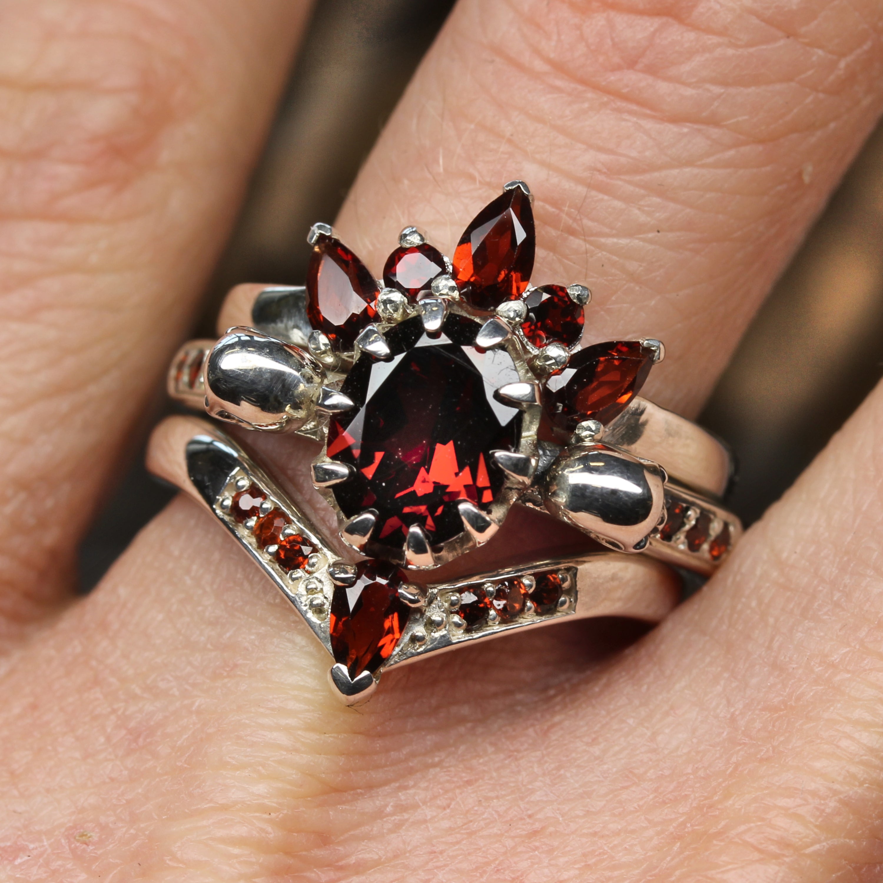 Triple stack Garnet ring. Eternity, engagement, and wishbone wedding ring. Pictured on finger.