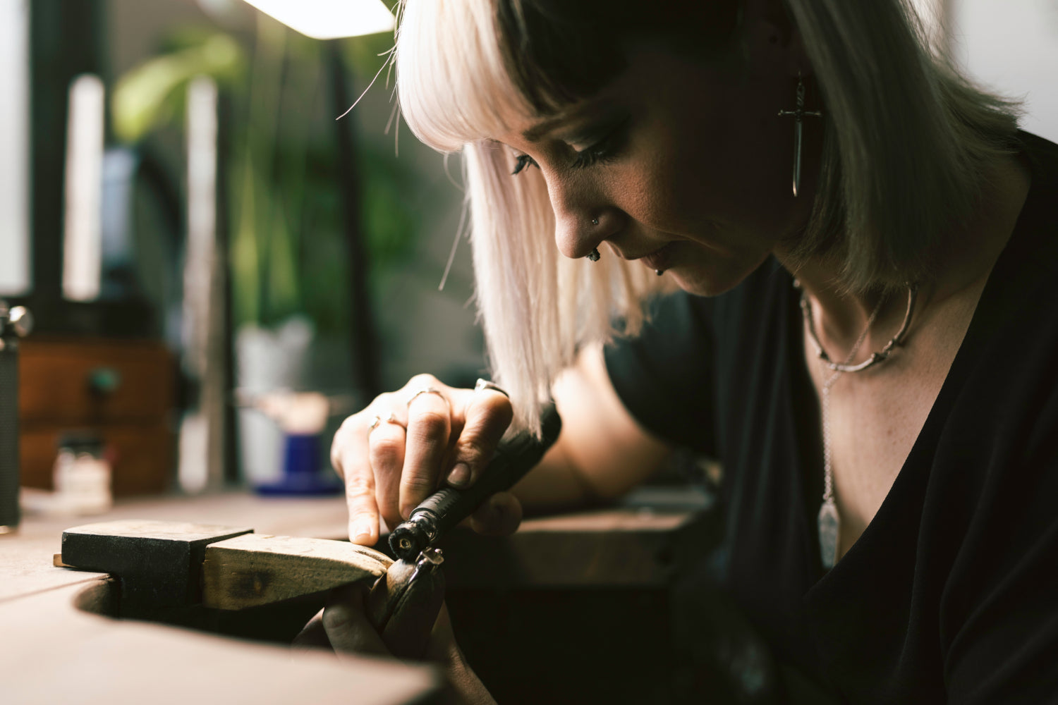 Hellcat Jewellery's Jo working on skull ring. Jo is wearing the sword earrings and bone necklace