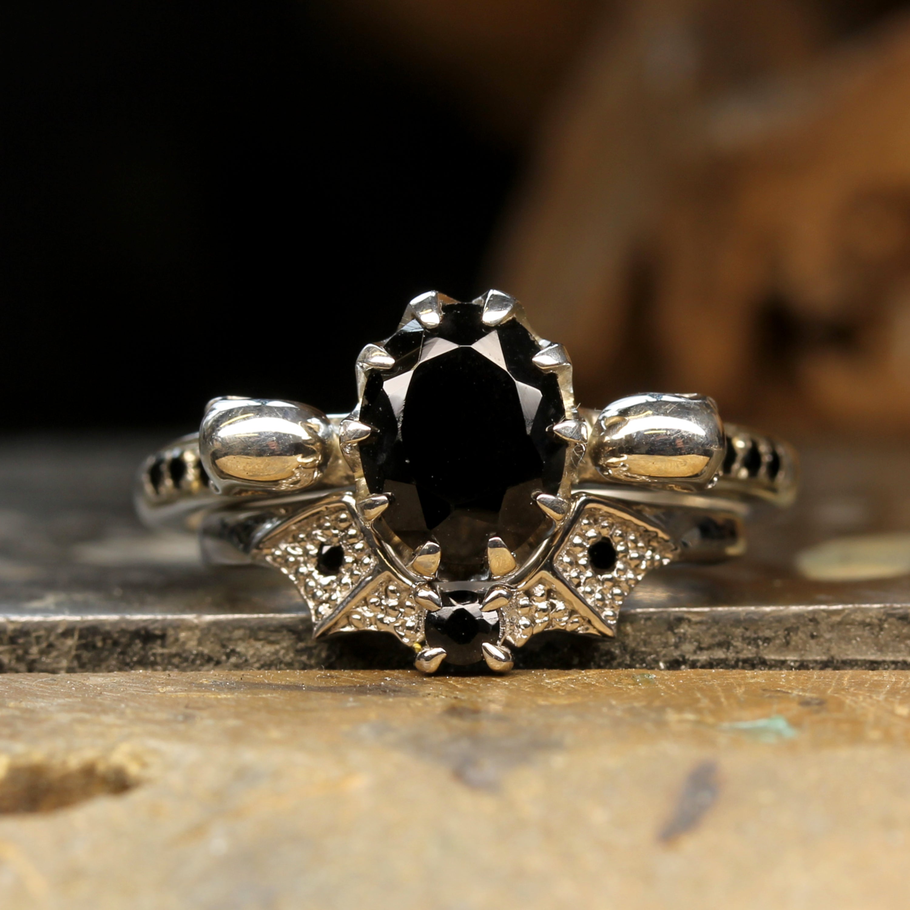 Oval Skull Engagement Ring Paired With Gothic Bat Wedding Ring. Black Gemstones