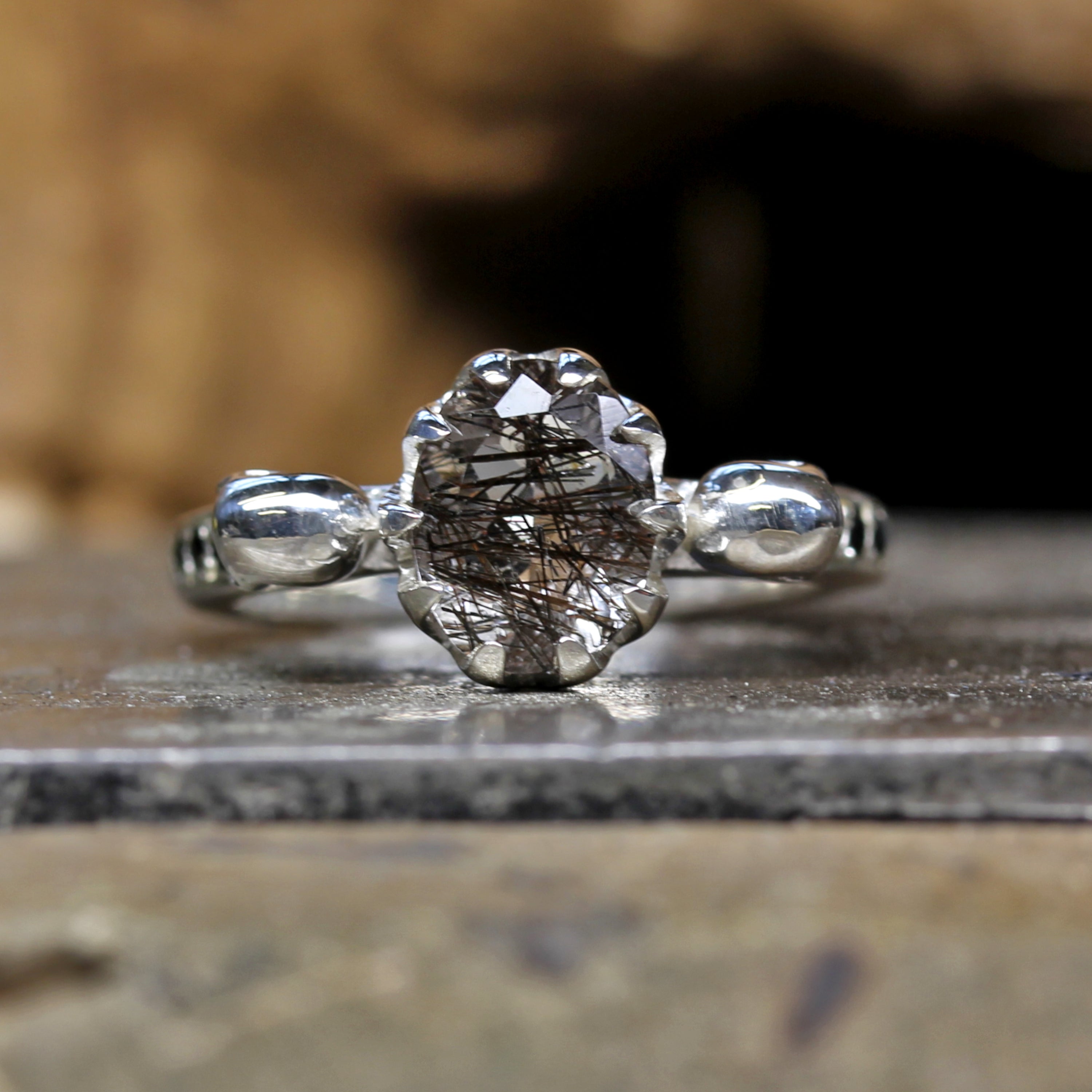 Oval Tourmalated Quartz Skull Engagement Ring on Table