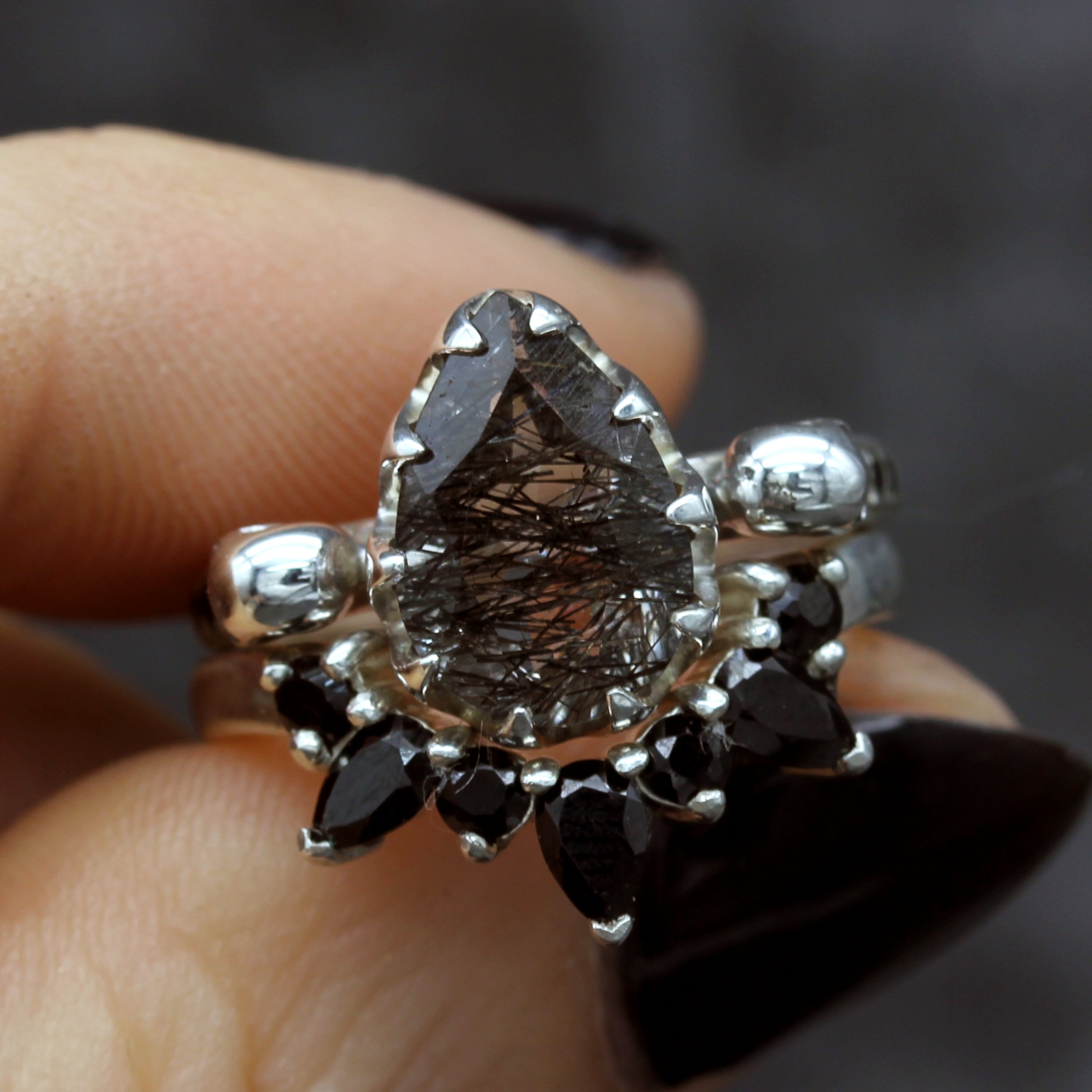 Gothic Wedding Ring paired with Pear cut Tourmalated Quartz Engagement Ring, on finger
