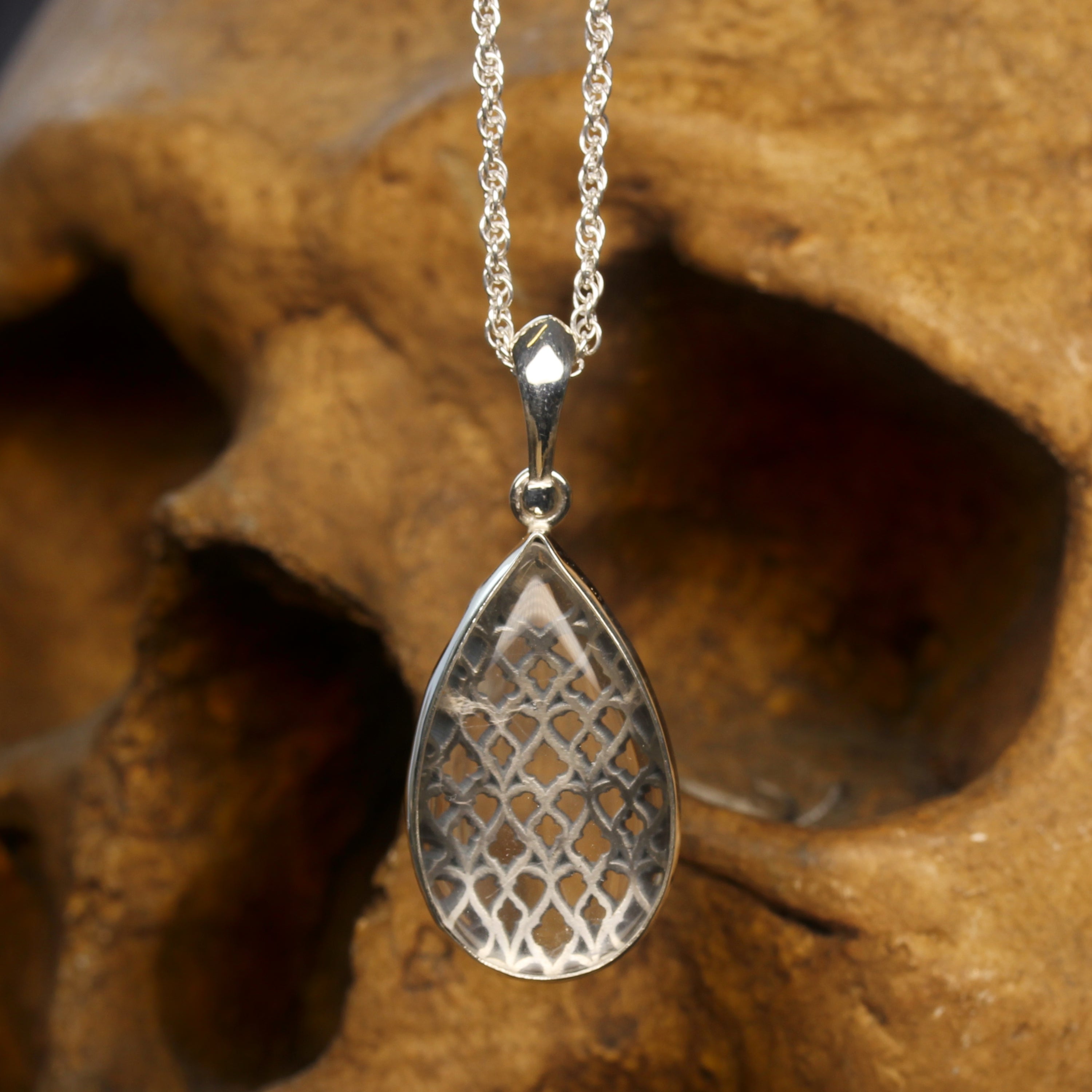 Silver Necklace with Pear Cut Clear Quartz in front of Cathedral Window Motifs
