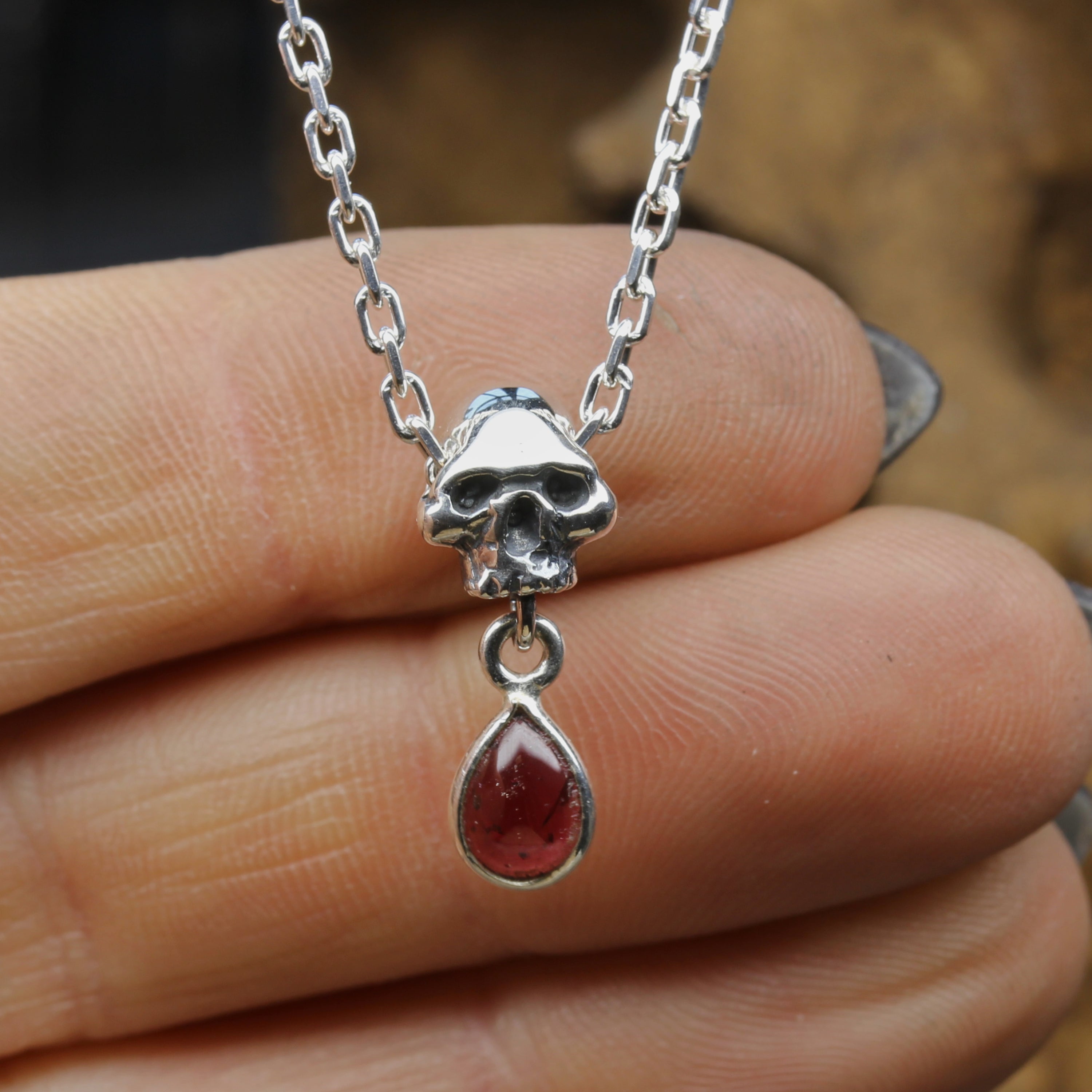 Silver Skull Necklace with Garnet Pendant