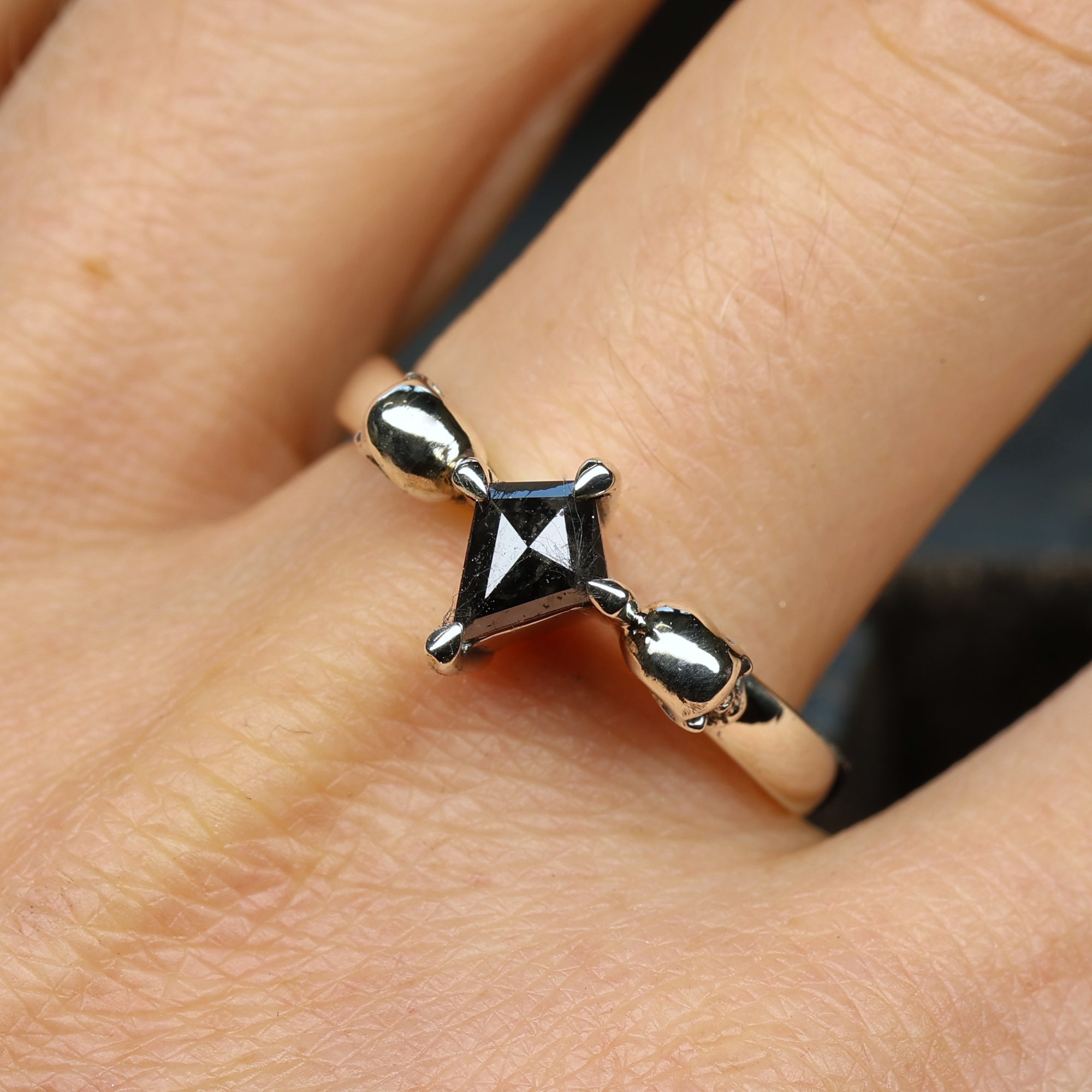 White gold skull engagement ring set with kite salt and pepper diamond